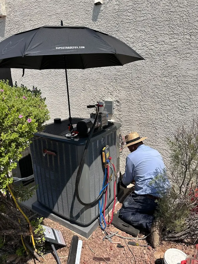 HVAC technician performing outdoor AC maintenance in Maywood